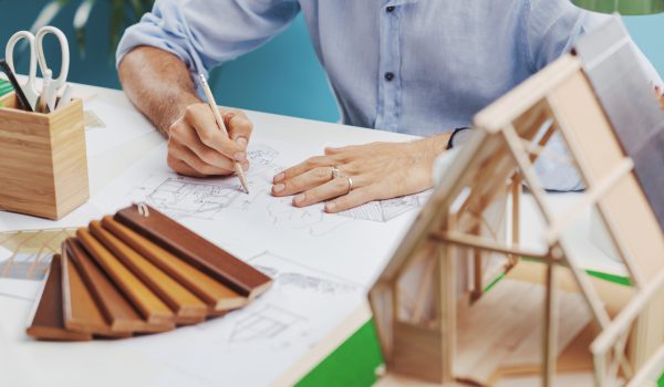 A young architect engaged in the design of an innovative modular, zero-impact housing structure. Concept of New Solutions for Sustainable Architecture.